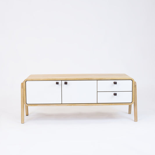 Low sideboard nm23L. The main corpus is crafted from solid Norwegian oak, featuring 2 doors and 2 right drawers, all with white fronts.