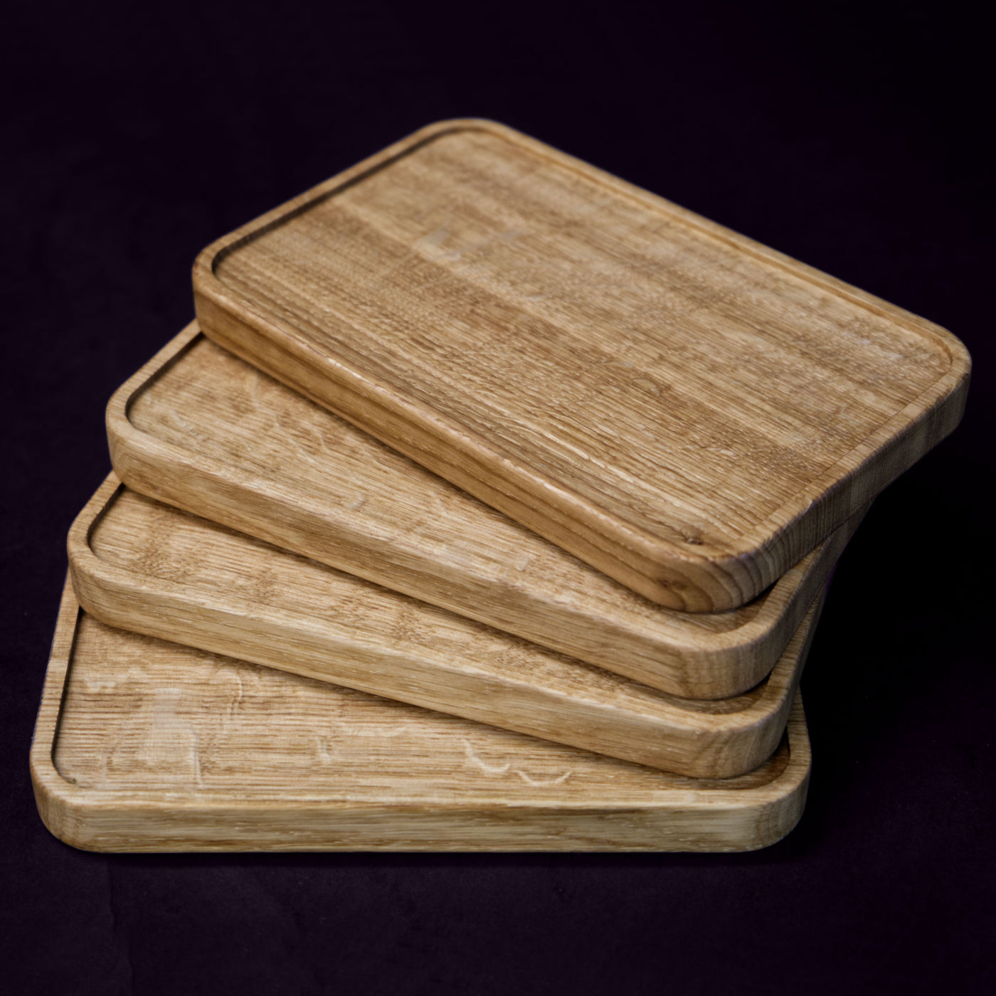 A set of 4 serving boards, handcrafted from solid Norwegian oak, featuring finely milled edges.