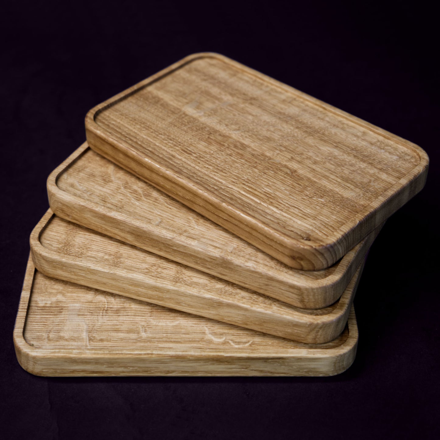 A set of 4 serving boards, handcrafted from solid Norwegian oak, featuring finely milled edges.