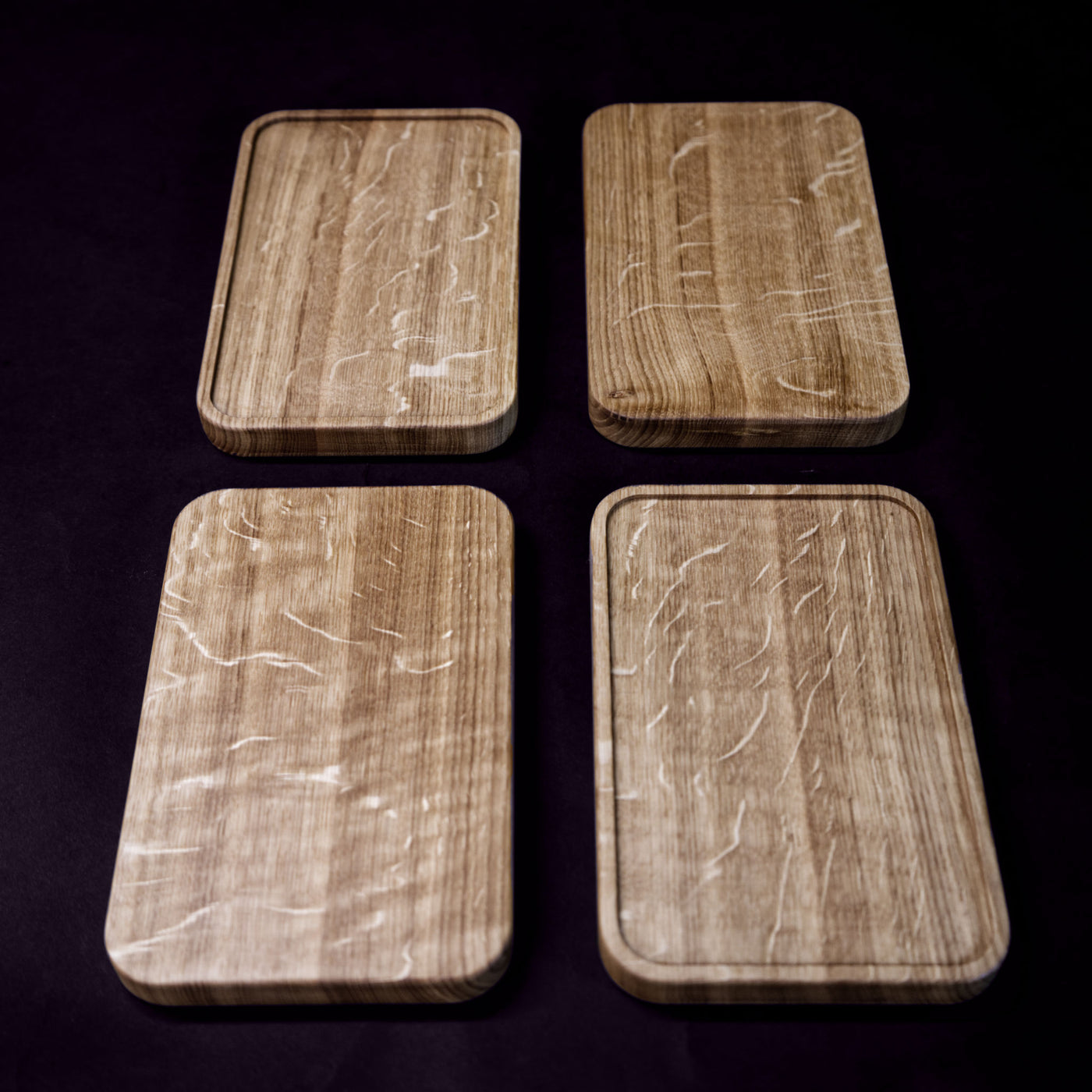 A set of 4 serving boards, handcrafted from solid Norwegian oak, featuring finely milled edges.