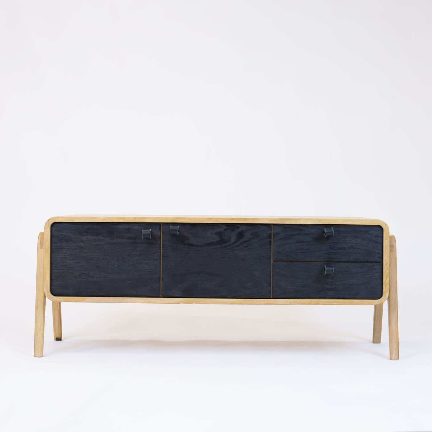 Low sideboard nm23L. The main corpus is crafted from solid Norwegian oak, featuring 2 doors and 2 right drawers, all with black oak fronts.