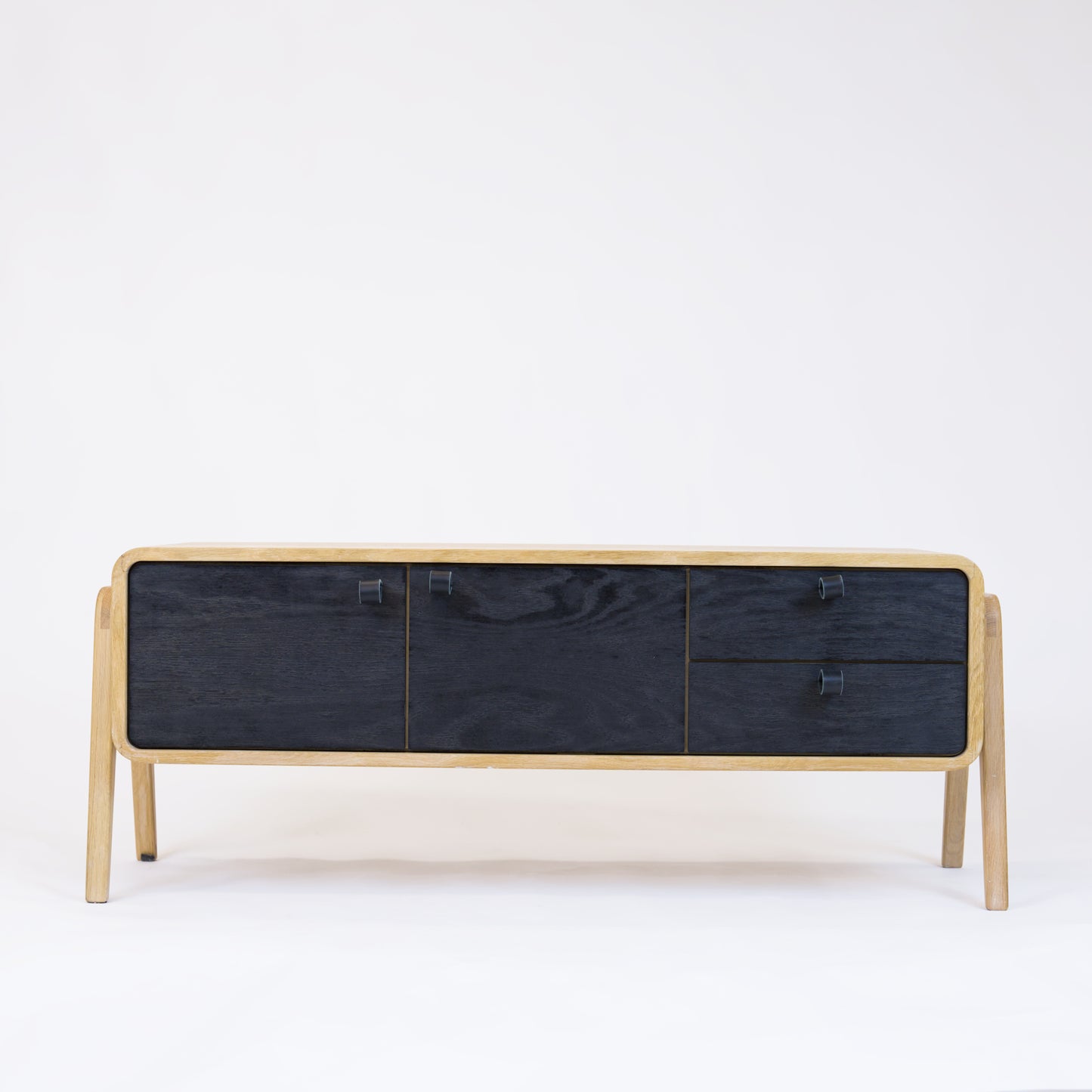 Low sideboard nm23L. The main corpus is crafted from solid Norwegian oak, featuring 2 doors and 2 right drawers, all with black oak fronts.