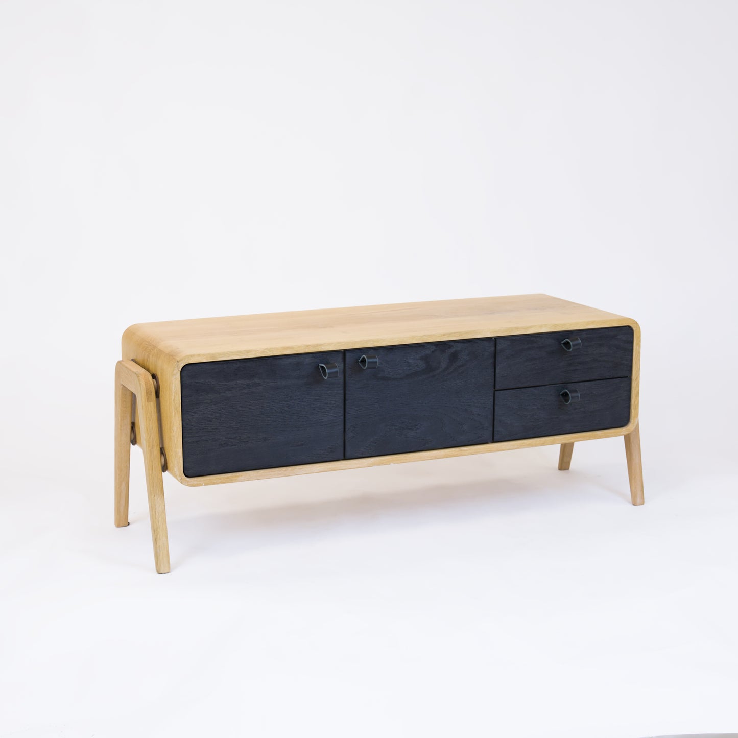 Low sideboard nm23L. The main corpus is crafted from solid Norwegian oak, featuring 2 doors and 2 right drawers, all with black oak fronts.