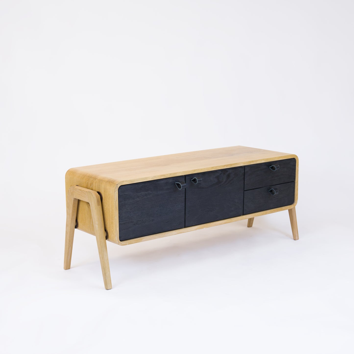 Low sideboard nm23L. The main corpus is crafted from solid Norwegian oak, featuring 2 doors and 2 right drawers, all with black oak fronts.