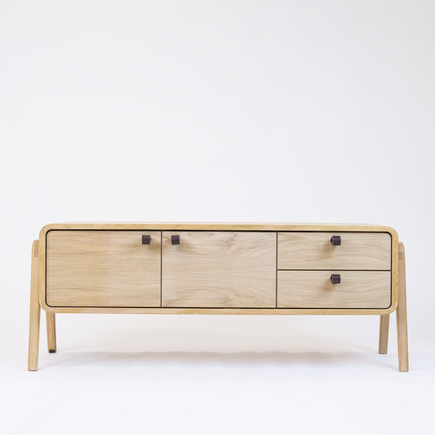 Low sideboard nm23L. The main corpus is crafted from solid Norwegian oak, featuring 2 doors and 2 right drawers, all with natural oak fronts.