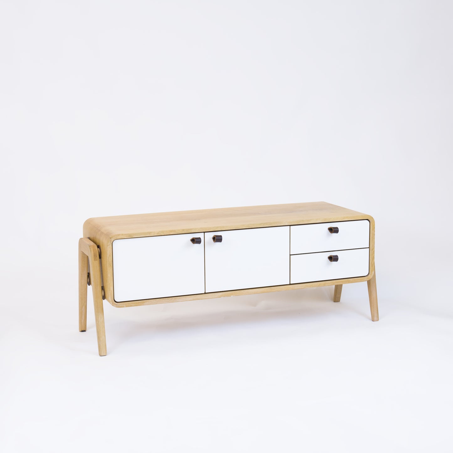 Low sideboard nm23L. The main corpus is crafted from solid Norwegian oak, featuring 2 doors and 2 right drawers, all with white fronts.
