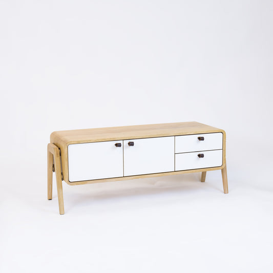 Low sideboard nm23L. The main corpus is crafted from solid Norwegian oak, featuring 2 doors and 2 right drawers, all with white fronts.