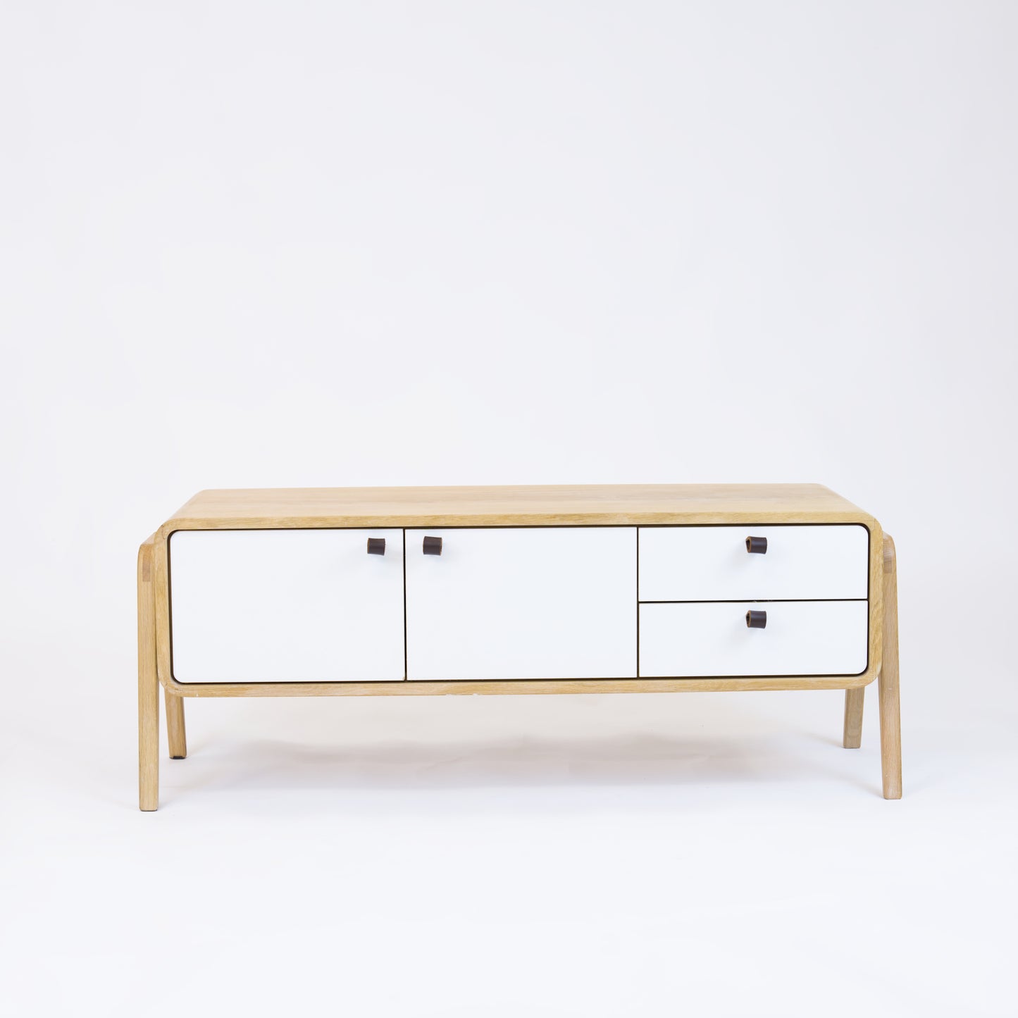 Low sideboard nm23L. The main corpus is crafted from solid Norwegian oak, featuring 2 doors and 2 right drawers, all with white fronts.
