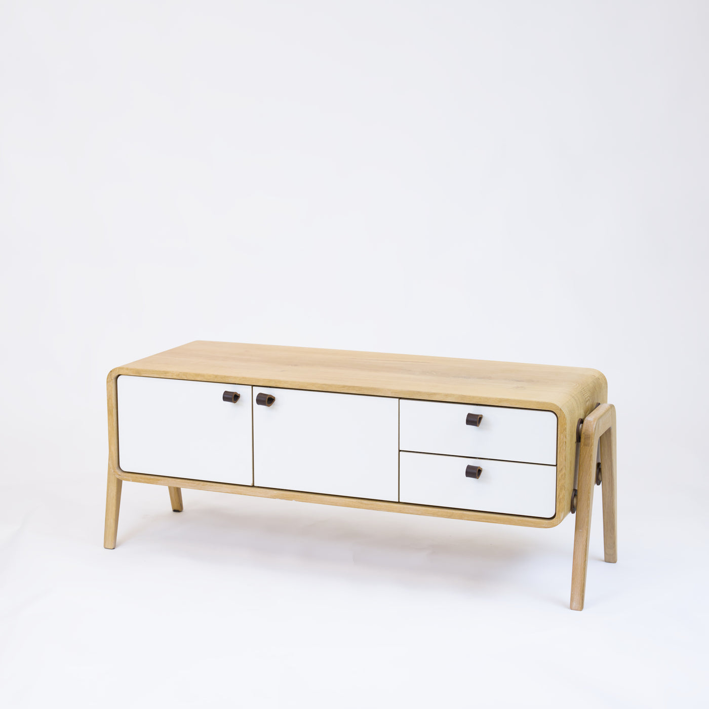 Low sideboard nm23L. The main corpus is crafted from solid Norwegian oak, featuring 2 doors and 2 right drawers, all with white fronts.