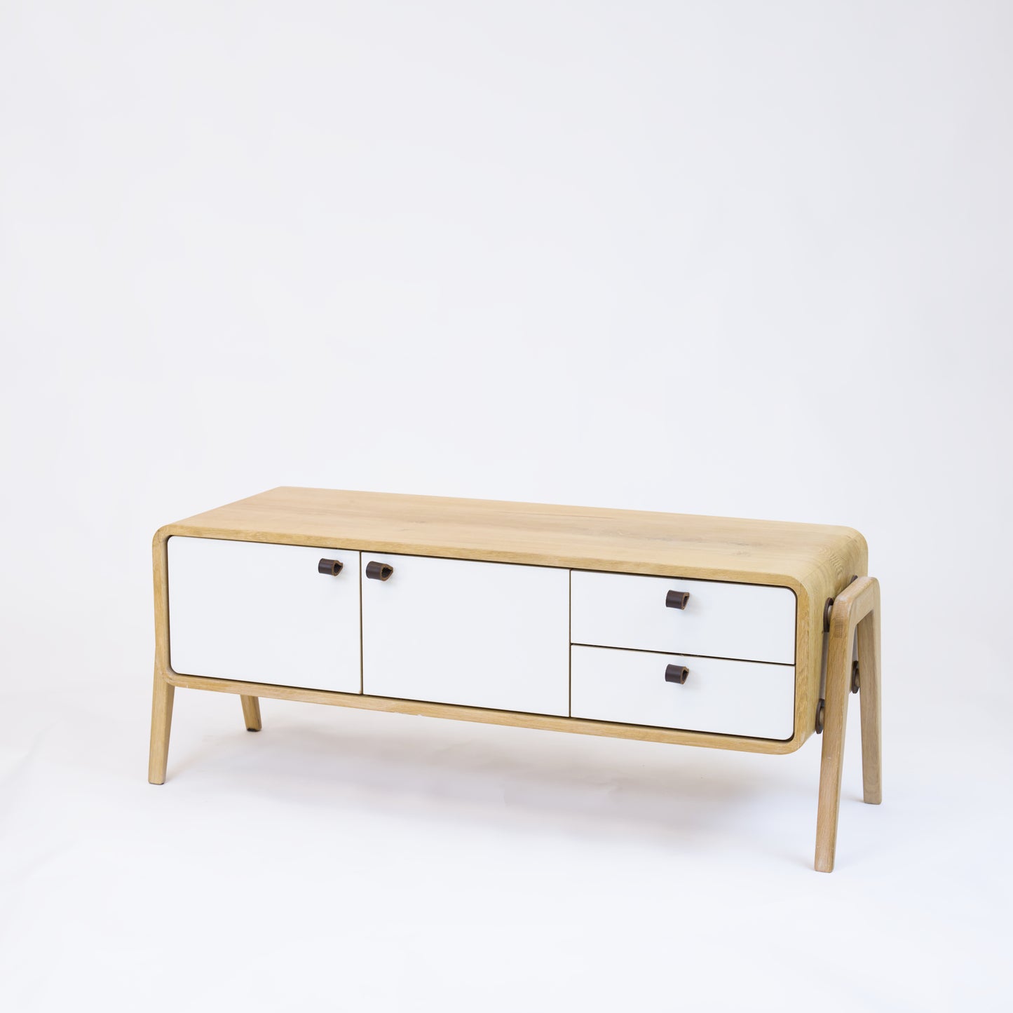 Low sideboard nm23L. The main corpus is crafted from solid Norwegian oak, featuring 2 doors and 2 right drawers, all with white fronts.