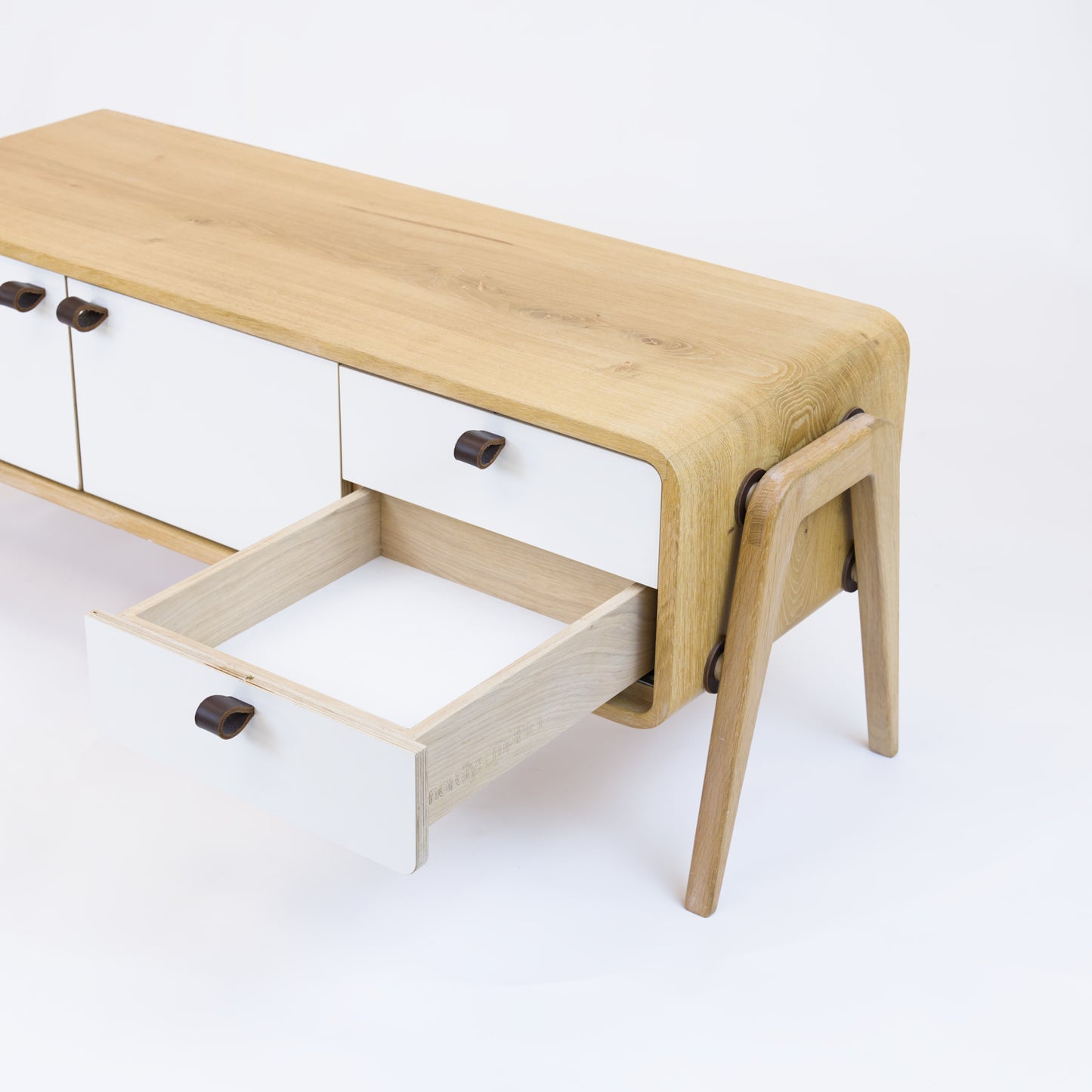 Low sideboard nm23L. The main corpus is crafted from solid Norwegian oak, featuring 2 doors and 2 right drawers, all with white fronts.